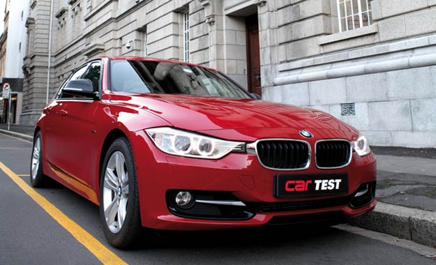 The striking red paint and gloss-black trim of this BMW 320i set it apart from rental-spec 3 Series.