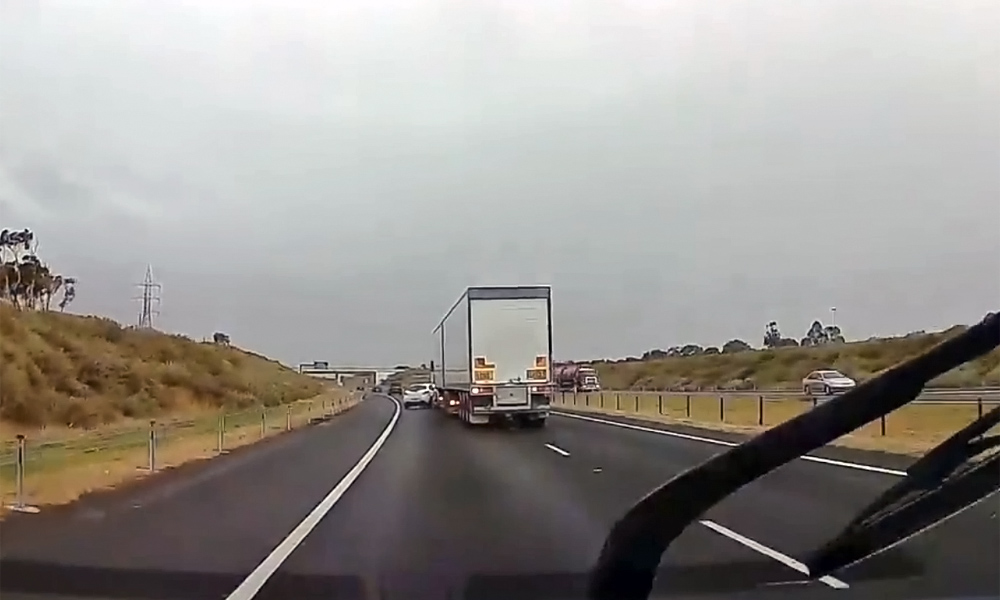 Truck switches lanes into Mazda2